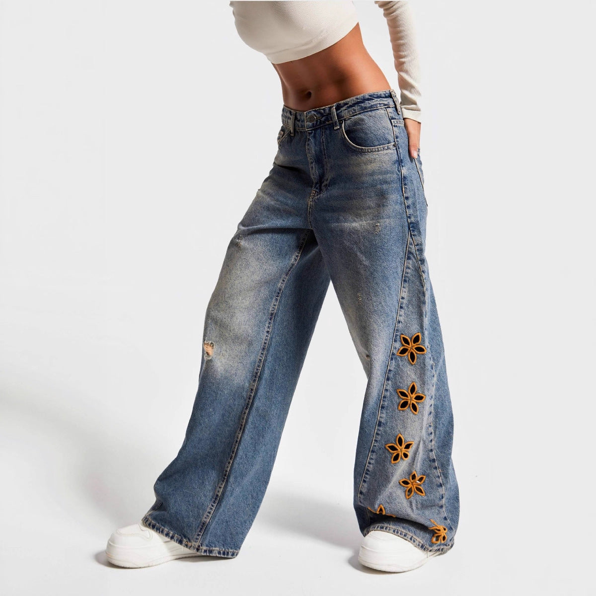 Jean femme taille haute coupe ample à motifs floraux ajourés